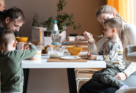 Photo of a multi-generational family sitting around a dining table sharing a meal