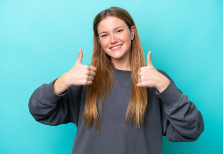 Young Caucasian Woman Isolated Blue Background Giving Thumbs Up Gesture